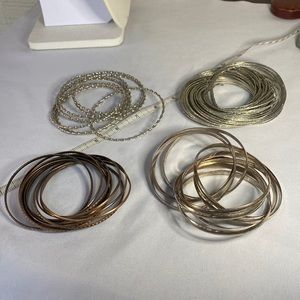 Set of four large interlocking silvertone and brass bracelets groups